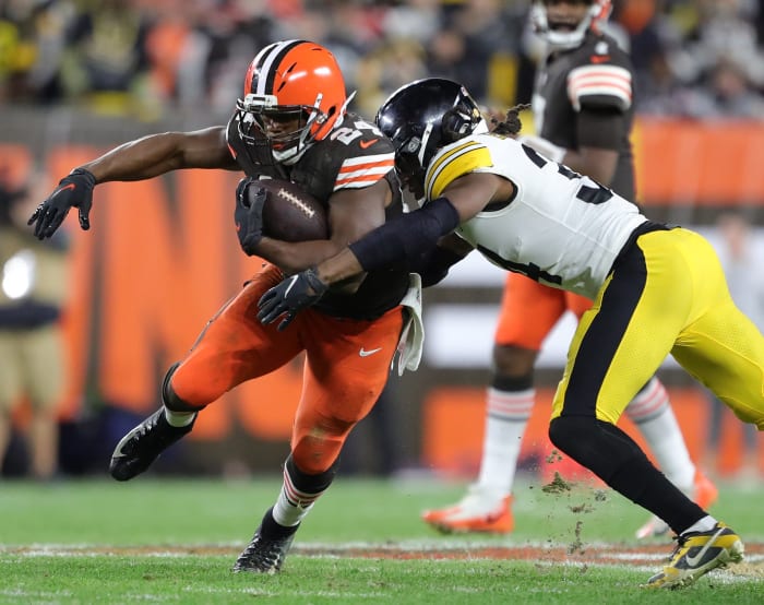 Browns running back Nick Chubb runs with the ball while Steelers safety Terrell Edmunds reaches out to tackle him